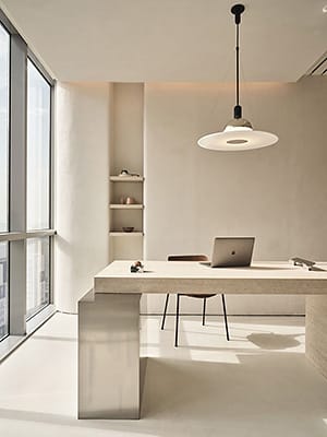 Minimalist office with a sleek desk, laptop, and natural lighting, symbolizing productivity, efficiency, and modern business strategy.