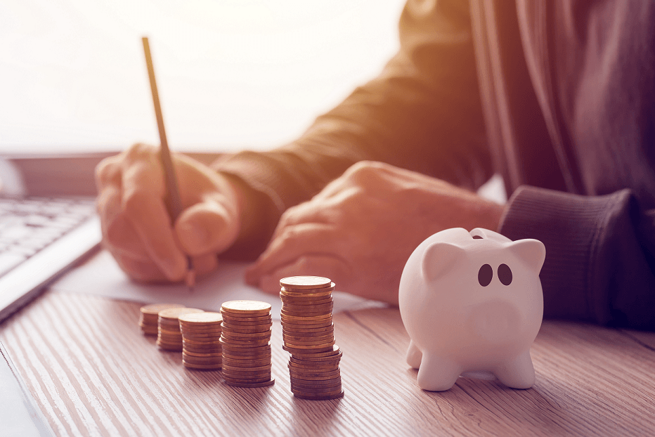 A business owner planning finances with a piggy bank and stacked coins, symbolizing smart budgeting, financial growth, and business success